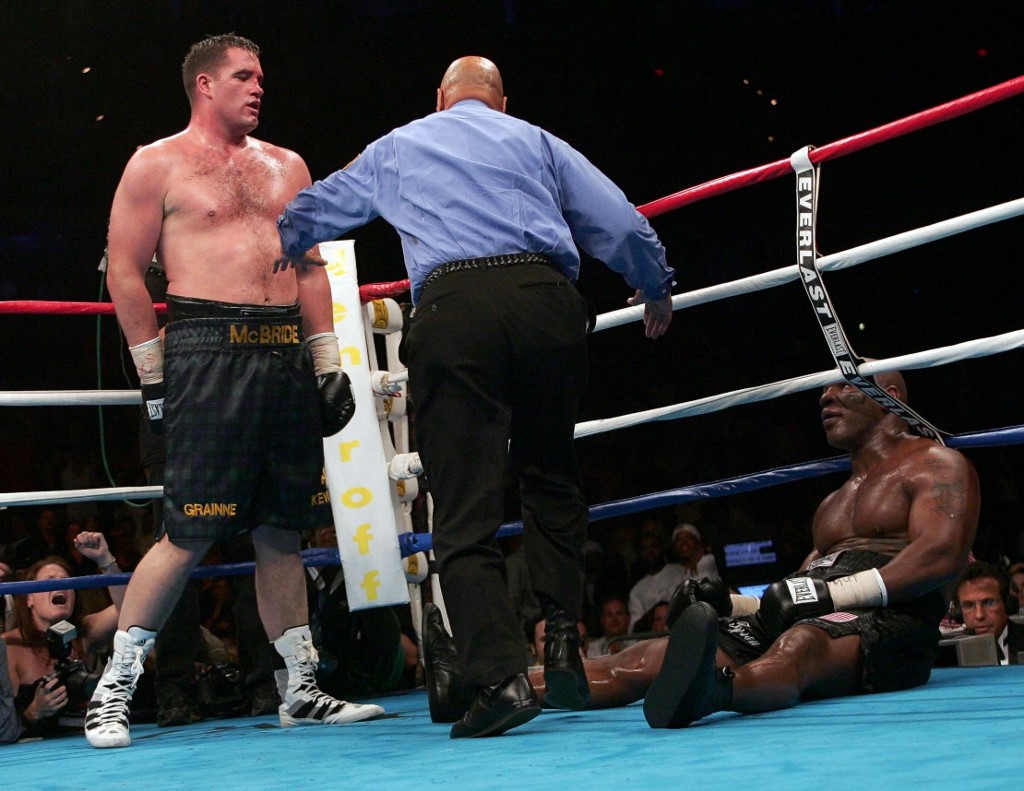 Former heavyweight champion ike Tyson (R) lies on the canvas after being pushed by Kevin McBride (L) of Ireland  11 June 2005 at the MCI Center in Washington, DC. Tyson learned the hard way that he no longer has the heart for boxing, taking a beating fromMcBride before quitting after six rounds in what he called his ring farewell.     AFP PHOTO/Paul J. RICHARDS (Photo by PAUL J. RICHARDS / AFP)